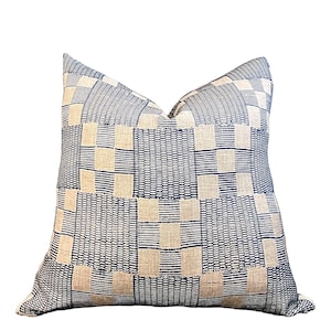 May include: A blue and white geometric patterned throw pillow. The pillow is made of a woven fabric with a subtle texture.