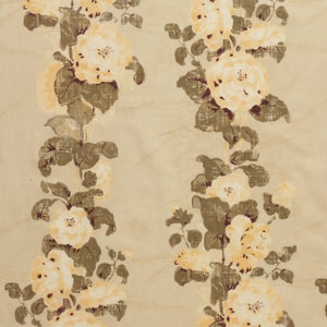 May include: A beige background with a repeating pattern of brown and yellow floral designs. The flowers are stylized and have a vintage look.