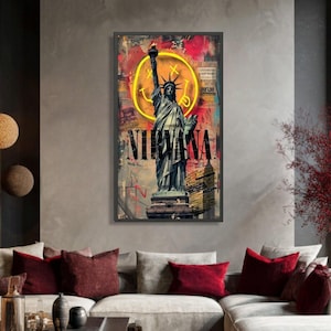 May include: A rectangular wall art print featuring the Statue of Liberty in a monochromatic tone. Behind the statue is a large yellow Nirvana smiley face logo. The background includes layered red and black abstract textures and the word NIRVANA.