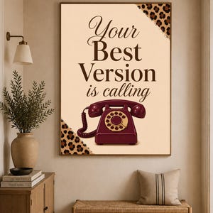 Peut inclure: Une affiche murale rectangulaire sur fond crème avec des coins à motif léopard marron. Le texte Your Best Version is calling est écrit en marron foncé au-dessus d'un téléphone à cadran vintage de couleur rouge foncé.