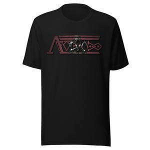 May include: A black short-sleeve t-shirt featuring a central graphic design. The print displays the text "AVOIDO" in a stylized, distressed dark red font with geometric shapes and lines integrated into the lettering, centered on the chest area.