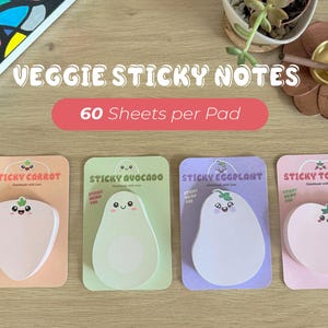 May include: Four pads of veggie sticky notes featuring carrot, avocado, eggplant, and tomato shapes with cute faces. Each pad contains 60 sheets. The packaging includes the text VEGGIE STICKY NOTES and 60 Sheets per Pad, with individual labels.