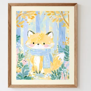 Peut inclure: Une impression d'art encadr&eacute;e repr&eacute;sentant un renard orange stylis&eacute; aux joues roses portant une &eacute;charpe bleu clair. Le renard est plac&eacute; dans un d&eacute;cor de for&ecirc;t avec des troncs d'arbres bleu clair, des feuilles d'automne jaunes et du feuillage vert.