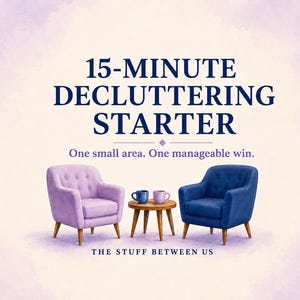 May include: A graphic featuring the text 15-MINUTE DECLUTTERING STARTER and One small area. One manageable win. Below the text are two upholstered armchairs, one light purple and one dark blue, flanking a small wooden table with two mugs.