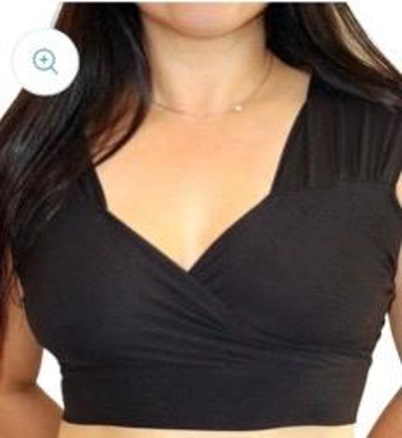 May include: Black crop top with a deep V-neck and a wrap-style design.