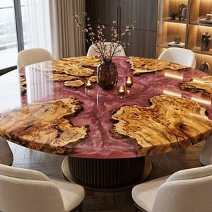 May include: A large round dining table featuring a polished surface with natural wood burl slabs embedded in a translucent deep pink resin. The table is supported by a dark cylindrical base and surrounded by eight cream-coloured upholstered chairs.