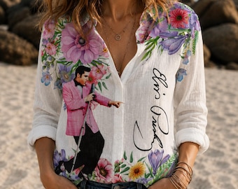 May include: A white long-sleeve button-down shirt featuring a graphic of Elvis Presley in a pink jacket and black trousers, surrounded by colorful floral patterns and the signature Elvis Presley printed in black script on the front.