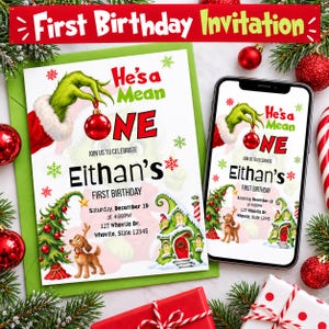 May include: A first birthday invitation card and a smartphone displaying the same digital invitation. The design features a green hand holding a red ornament, the text He's a Mean ONE, Eithan's FIRST BIRTHDAY, and a brown dog near a house.