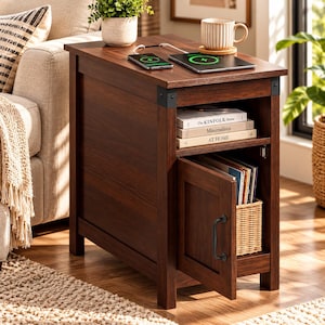 May include: A dark brown wooden end table with a top surface featuring a wireless charging pad, a smartphone, and a ceramic mug. The table includes an open shelf holding three books and a lower cabinet with a door and a woven storage basket.