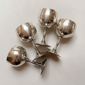 May include: A set of three ceramic mugs with a speckled, matte finish. The mugs are in shades of cream, light brown, and dark brown. Each mug has a simple, minimalist design, perfect for coffee or tea.