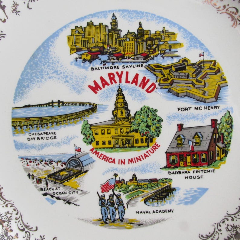 May include: A white ceramic plate with a colorful illustration of Maryland landmarks, including the Baltimore skyline, Fort McHenry, the Chesapeake Bay Bridge, the State House, the Naval Academy, and Barbara Fritchie House. The plate features the text "Maryland, America in Miniature".