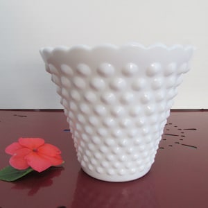 May include: White milk glass vase with a scalloped rim and a textured, dotted surface.