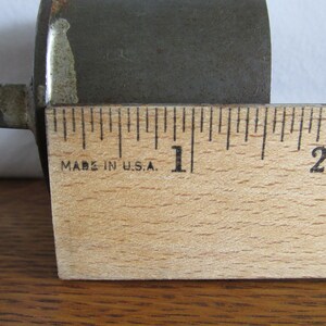 May include: A close-up of a wooden ruler with black markings. The ruler is marked with inches and has the text "Made in U.S.A." printed on it.