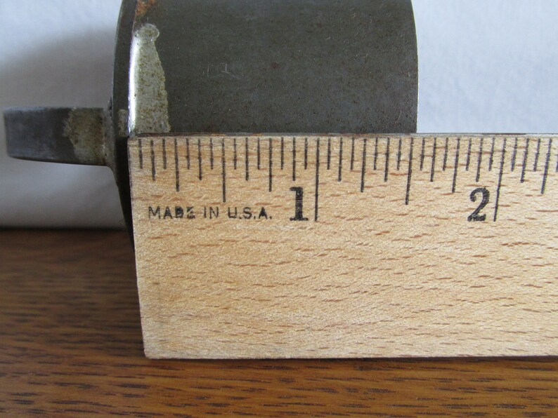 May include: A close-up of a wooden ruler with black markings. The ruler is marked with inches and has the text "Made in U.S.A." printed on it.