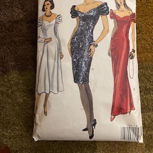 May include: Vogue Patterns sewing pattern envelope featuring illustrations of three different evening gowns. The envelope is white with the Vogue Patterns logo and the pattern number 7958. The size range is 6-8-10.