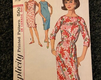 May include: Simplicity sewing pattern number 5203 for a dress. The pattern is for a miss, medium size 14-16. The pattern shows three different styles of dresses, one with a floral print, one with a solid blue print, and one with a floral print. The pattern is printed on a white background with black text.