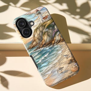 May include: A smartphone case featuring a detailed illustration of a coastal scene with a lighthouse perched on a rocky cliff above a sandy beach. The artwork includes blue ocean waves, two small shorebirds walking on the sand, and a seashell.