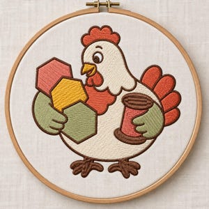 May include: An embroidery hoop containing a white fabric panel with a stitched design of a white chicken with a red comb and wattle. The chicken holds three colorful hexagons in shades of pink, yellow, and green, and a brown thread spool.