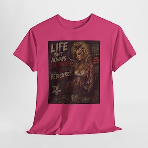 May include: A bright pink short-sleeve t-shirt featuring a graphic print of a person with voluminous hair holding a cigarette and a bottle. The text reads: LIFE ISN'T ALWAYS STARBUCKS & PEDICURES. BEER TOBACCO REGRET. The design includes a skull logo.