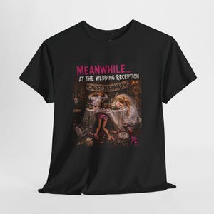 May include: A black t-shirt featuring a graphic print with the text "MEANWHILE... AT THE WEDDING RECEPTION" and "JUST MARRIED". The illustration depicts a chaotic wedding scene with dolls at a table, scattered debris, and a "GAME OVER" sign.