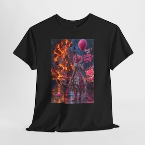 May include: A black t-shirt featuring a graphic print of a clown in a ruffled dress holding a pink balloon. The background shows a burning carnival with a Ferris wheel and the text "Should I get cotton candy?" printed in a stylized pink font.