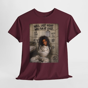May include: A maroon t-shirt featuring a graphic print of a person in a white straightjacket sitting in a padded room. The text reads: WELL, LAST NIGHT WAS FUN AT LEAST..., I'M FINE, PATIENT BARRIE ROOM 17, THEY'RE ALL FAKE, and NO. A small DL XXVIII logo is visible.