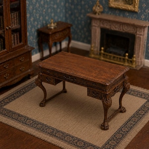 May include: A miniature wooden desk with a dark brown finish, featuring a rectangular top, multiple small drawers with metal pulls, and curved legs ending in carved feet. The desk is designed for a dollhouse setting and displays intricate wood grain.