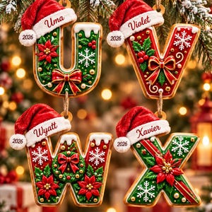 May include: Four hanging Christmas ornaments shaped like the letters U, V, W, and X. Each letter is decorated with red poinsettias, green holly, white snowflakes, and a red bow. A red Santa hat with the names Uma, Violet, Wyatt, and Xavier and 2026.