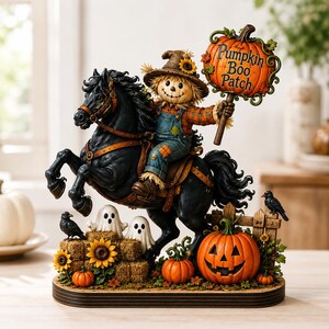 May include: A decorative figurine featuring a scarecrow riding a black horse. The scarecrow wears a hat with a sunflower and holds a sign that reads Pumpkin Boo Patch. The base includes hay bales, two white ghosts, sunflowers, and pumpkins.