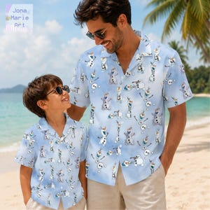 May include: Two light blue short-sleeved button-down shirts featuring an all-over print of the character Olaf from Frozen. The shirts have a notched collar, a front button closure, and a repeating pattern of the snowman in various poses.