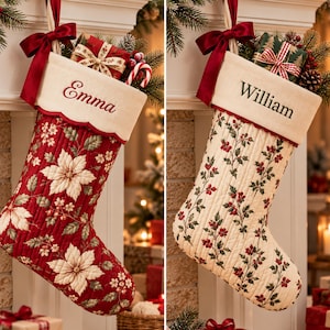 May include: Two quilted Christmas stockings hanging with red bows. The left stocking is red with white poinsettias and embroidered with the name Emma. The right stocking is cream with holly berries and leaves and embroidered with the name William.