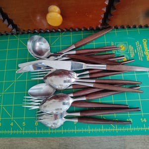 Mismatched collection of mid century wood handled silverware