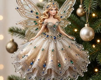 May include: A flat, translucent acrylic Christmas tree ornament shaped like a fairy with long blonde hair, wearing a cream-colored gown adorned with intricate gold filigree, blue and green gemstone accents, and a delicate lace-patterned hem.