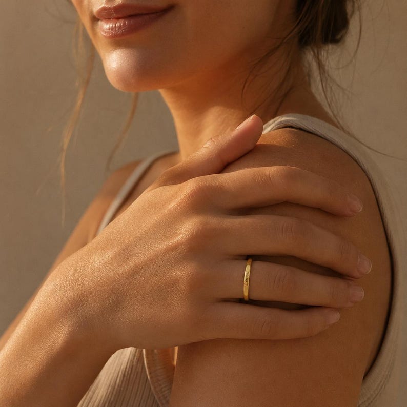 Woman wearing a sterling silver engraved name ring on her finger