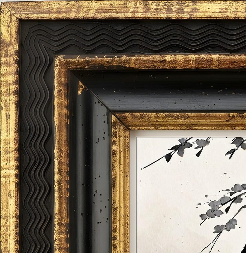 May include: A decorative picture frame featuring a multi-layered design with a wavy black outer edge, a smooth black inner border, and distressed gold leaf accents on the raised surfaces. The frame surrounds a white print with black ink branches.