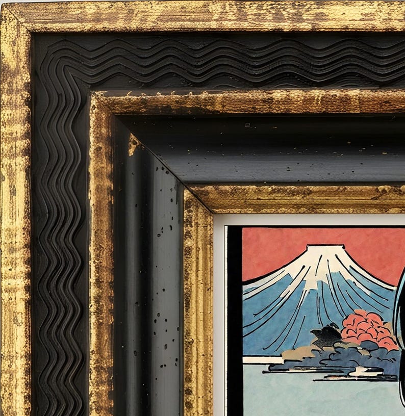 May include: A rectangular picture frame with a black and gold finish featuring a wavy inner border and a flat outer edge. The frame surrounds a print depicting a mountain with a snow-capped peak against a red sky, blue water, and foliage.