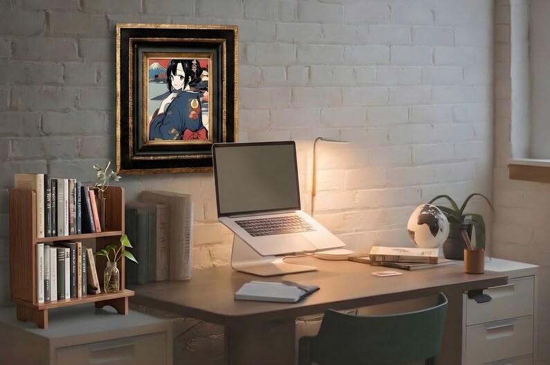 May include: A framed anime-style illustration of a dark-haired character in a blue kimono, displayed on a white brick wall above a wooden desk with a laptop on a stand, a small bookshelf, a globe, and a desk lamp in a home office setting.
