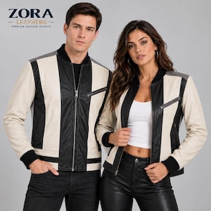 May include: Two bomber jackets featuring a colour-blocked design of cream, black, and grey leather panels. Each jacket includes a central silver zip, a black ribbed collar, black ribbed cuffs, and a diagonal zipped chest pocket on the left side.