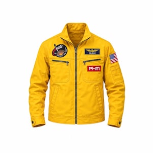 May include: A mustard yellow jacket featuring a full-length front zipper, a stand-up collar, and two chest pockets. Patches include a circular Project Hail Mary emblem, a Grace name tag, a red PHM rectangle, and a United States flag on the sleeve.