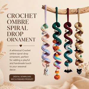 May include: Four crochet spiral drop ornaments hanging from a wooden branch. The first is pastel ombre with star charms and a ghost. The second is rainbow ombre with pumpkin and candy corn charms. The third is dark green and maroon with bat charms. The fourth is tan with witch hat and cat charms.