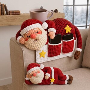 May include: A crochet Santa Claus sofa armrest organizer featuring a red hat, white beard, and two pockets containing black rectangular devices, accompanied by a separate smaller crochet Santa Claus figurine lying down, both with yellow star accents.