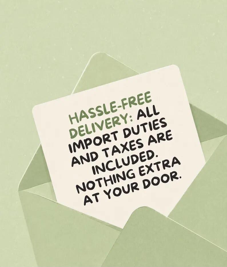 May include: A light green envelope containing a white card with the text: HASSLE-FREE DELIVERY: ALL IMPORT DUTIES AND TAXES ARE INCLUDED. NOTHING EXTRA AT YOUR DOOR. The text is printed in a dark green, sans-serif font on the card surface.