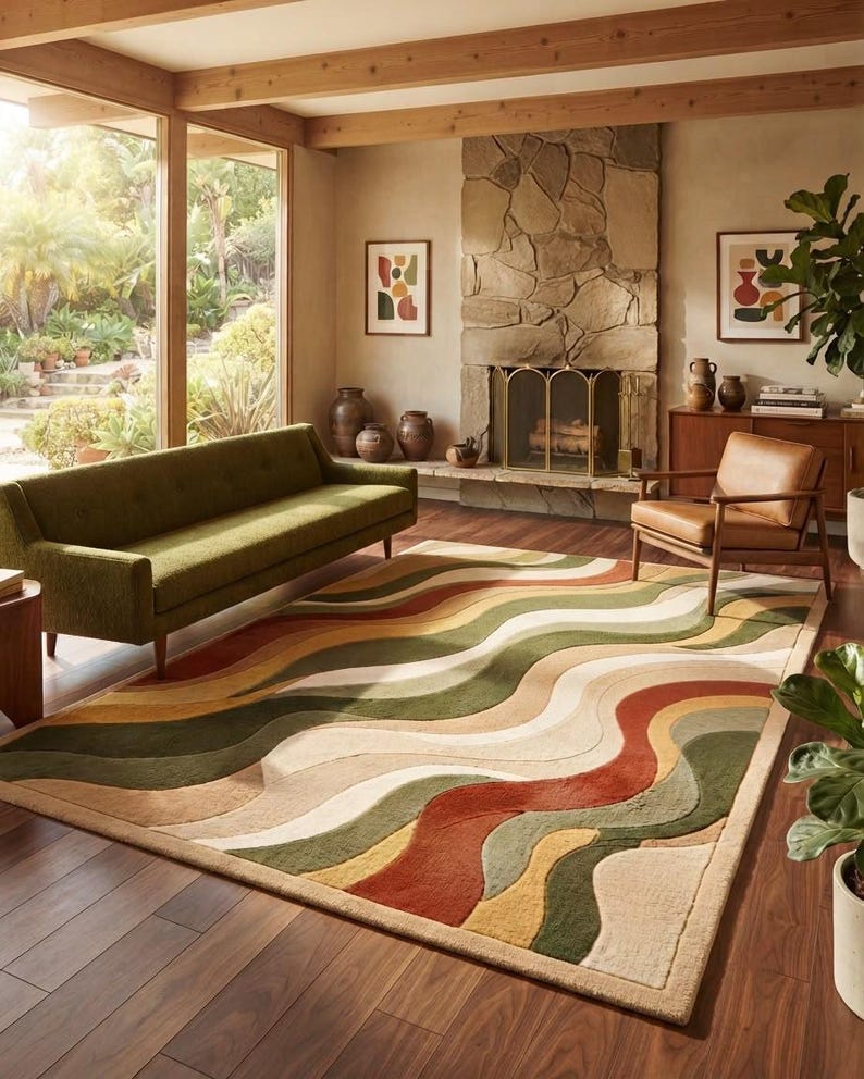 May include: A rectangular area rug featuring a wavy, multi-colored pattern of olive green, burnt orange, cream, and tan stripes. The rug has a textured, tufted surface with distinct color-blocked sections that create a flowing, organic design.
