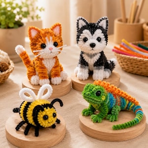 May include: Four small animal figures crafted from fuzzy pipe cleaners, including an orange and white tabby cat, a black and white husky puppy, a yellow and black bumblebee with white wings, and a multi-colored green, blue, and orange lizard.