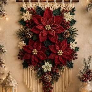 May include: A wall hanging featuring crocheted red poinsettia flowers, dark green leaves, and small cream-colored blossoms. The arrangement includes brown pinecones and red berries, all suspended from a wooden rod with cream-colored macrame cord.