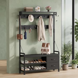 May include: A black metal hall tree featuring a top shelf, multiple coat hooks, a bench seat, two open shoe storage shelves, and two drawers. The unit holds various items including a hat, coat, scarf, backpack, and several pairs of shoes.