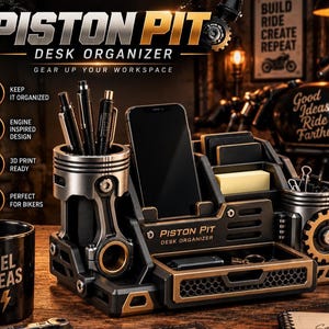 Puede incluir: Un organizador de escritorio negro y metálico con la etiqueta Piston Pit, que cuenta con dos portalápices cilíndricos con forma de pistones de motor, un soporte central para smartphone, una pequeña bandeja de almacenamiento y un detalle de engranaje.