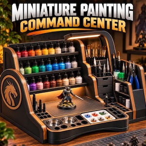 May include: A black and copper miniature painting command centre featuring three tiered shelves for paint bottles, a central workspace with a cutting mat, integrated LED lighting, brush storage, drawers, and a palette with paint wells.