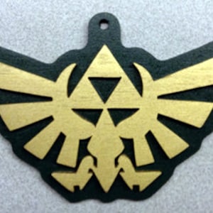 May include: A gold-colored wooden ornament featuring the iconic Triforce symbol from the Legend of Zelda video game series. The Triforce is surrounded by stylized wings, creating a dynamic and recognizable design.
