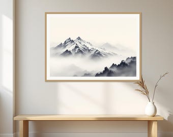 May include: A framed landscape print featuring a mountain range with snow-capped peaks partially obscured by thick, low-hanging clouds. The artwork uses a monochromatic palette of white, grey, and black tones, presented in a light wood frame.